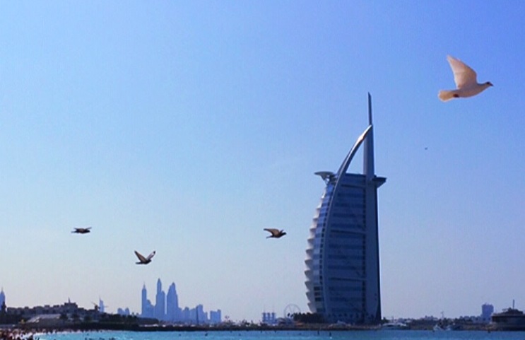 Burj al Arab with bird flying across the sky